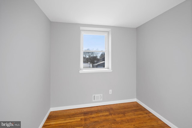 unfurnished room featuring dark hardwood / wood-style flooring