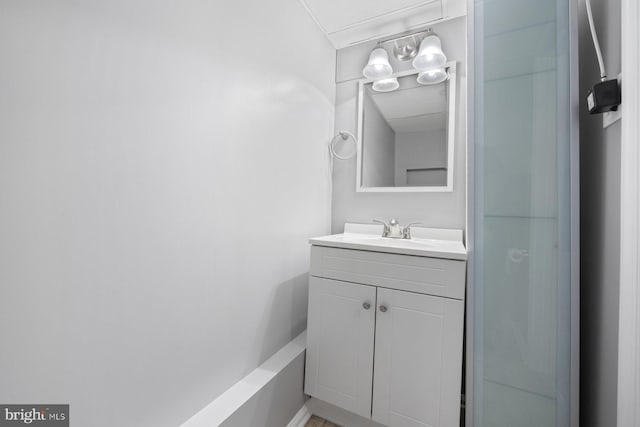 bathroom featuring a shower and vanity