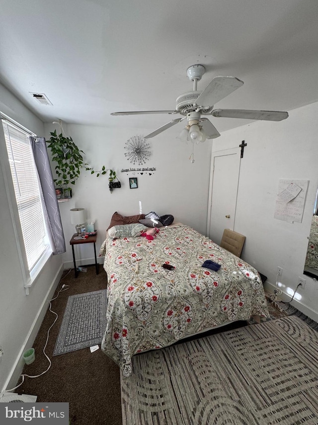 bedroom featuring ceiling fan and dark carpet