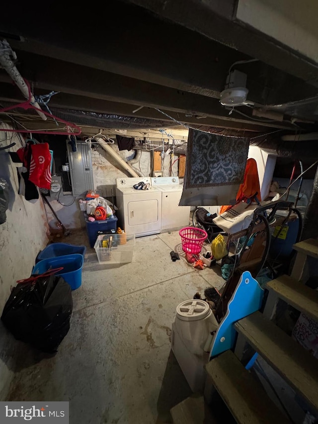 basement featuring washer and clothes dryer and electric panel