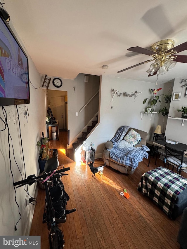 interior space with ceiling fan and wood-type flooring