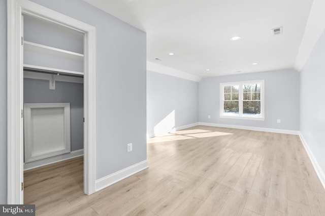 interior space with lofted ceiling and light hardwood / wood-style flooring