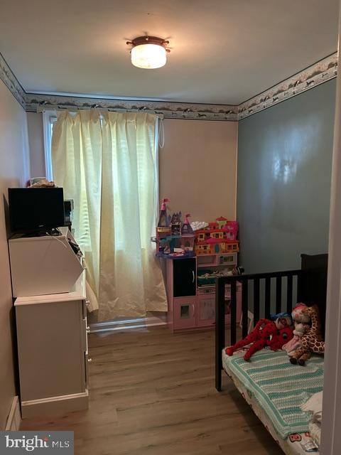 bedroom with hardwood / wood-style floors