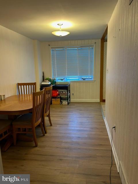 dining space with hardwood / wood-style floors