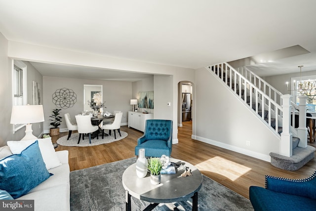 living room with a chandelier and hardwood / wood-style flooring