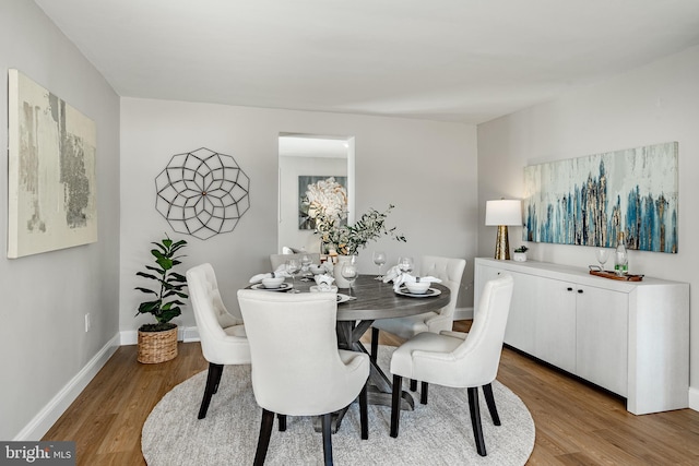 dining space with hardwood / wood-style flooring