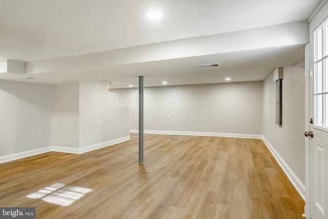 basement featuring light hardwood / wood-style floors