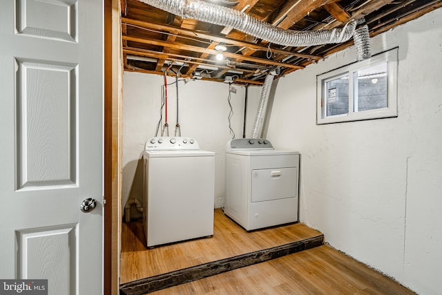 washroom featuring washer and dryer and wood-type flooring