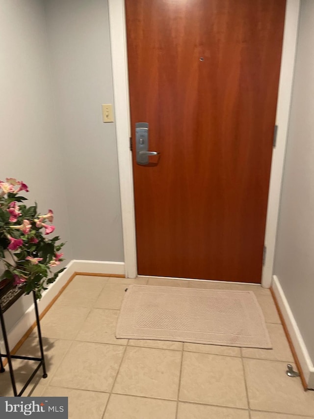 doorway to outside with tile patterned floors