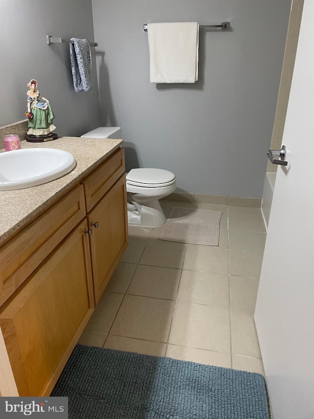 bathroom with tile patterned floors, vanity, and toilet