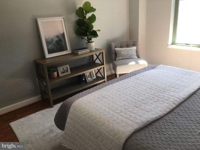 bedroom with dark wood-type flooring