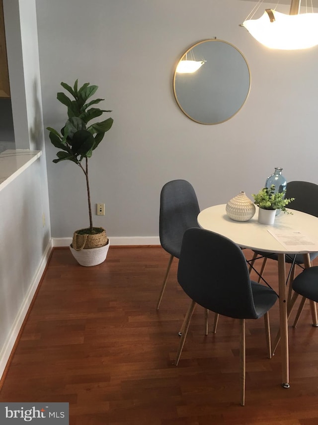 dining space featuring dark hardwood / wood-style flooring