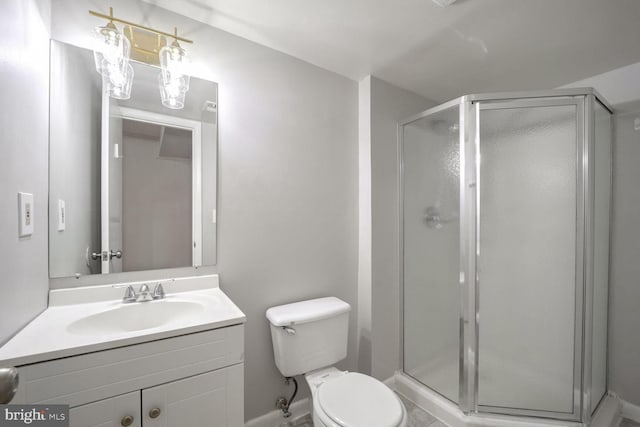 bathroom featuring vanity, toilet, and an enclosed shower