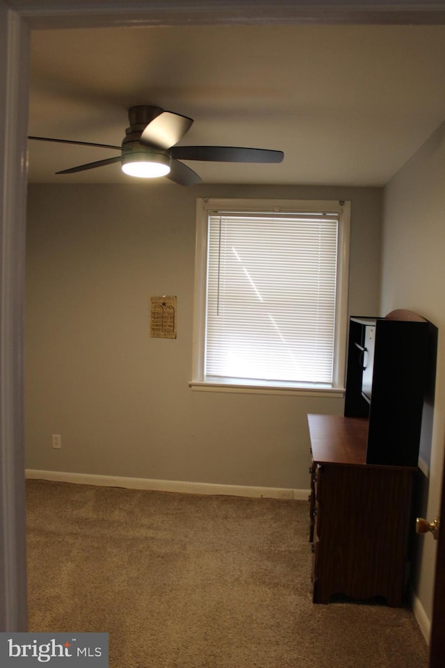 carpeted empty room with ceiling fan