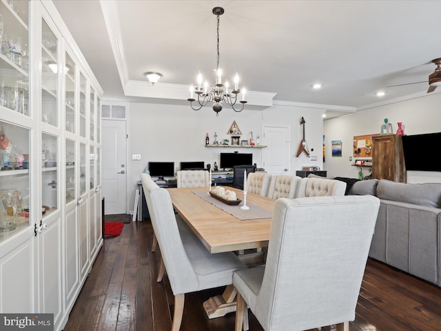 dining space featuring crown molding, dark wood-type flooring, and ceiling fan with notable chandelier