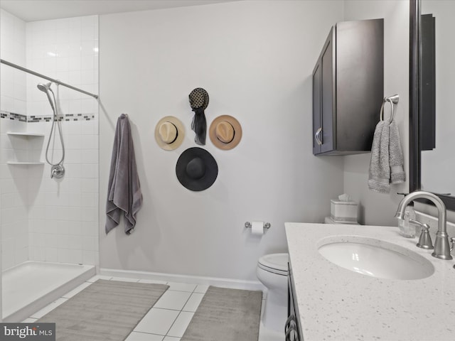 bathroom with tiled shower, tile patterned floors, vanity, and toilet