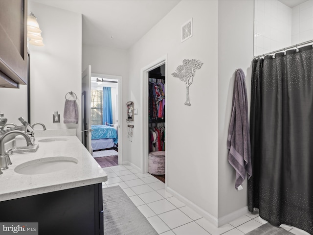 bathroom with tile patterned floors, vanity, and a shower with shower curtain