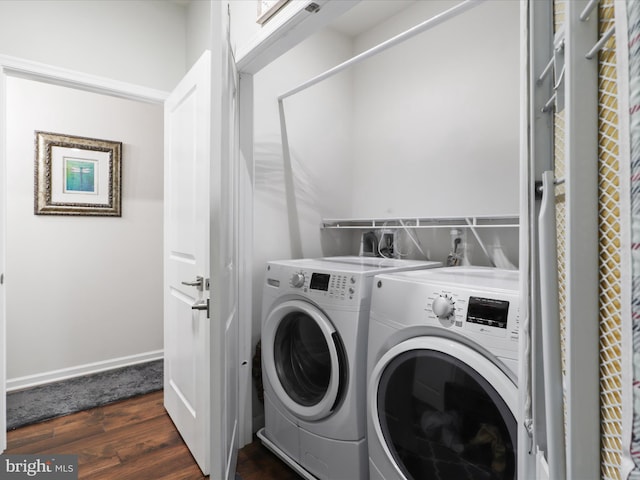 laundry area with separate washer and dryer and dark wood-type flooring