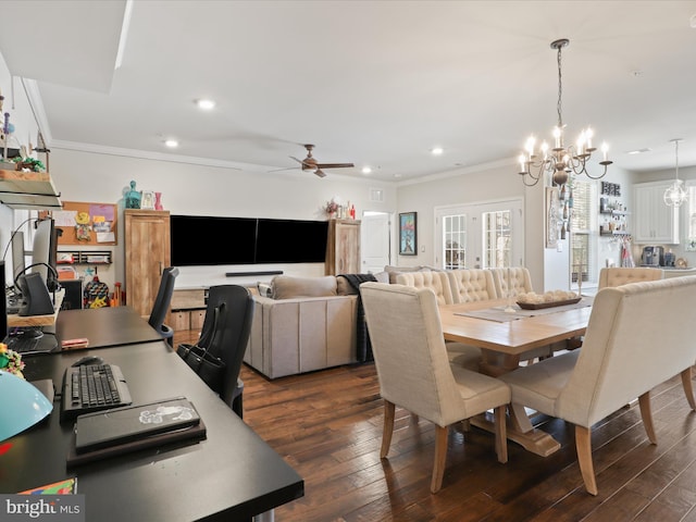 dining space with ceiling fan with notable chandelier, crown molding, and dark wood-type flooring