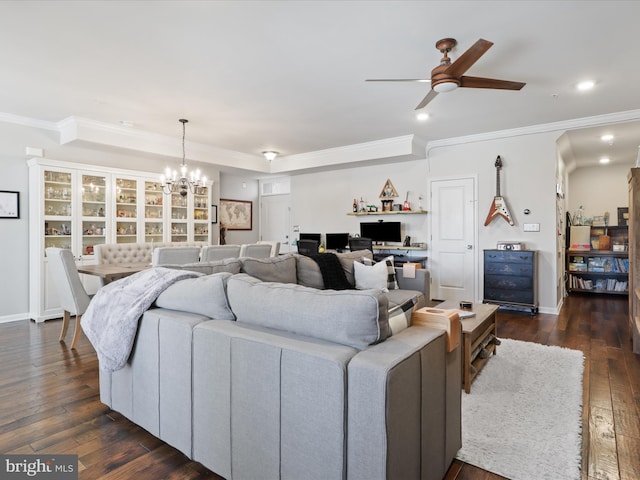 living room featuring dark hardwood / wood-style floors, ornamental molding, and ceiling fan with notable chandelier