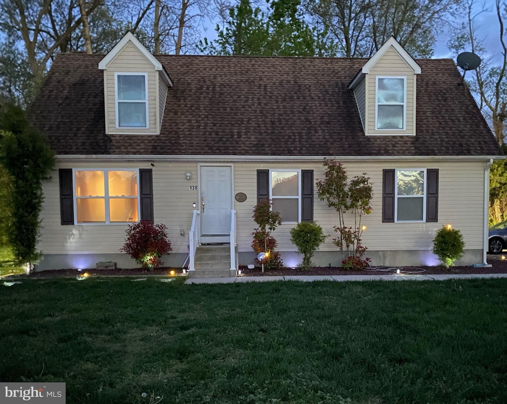 new england style home with a front yard