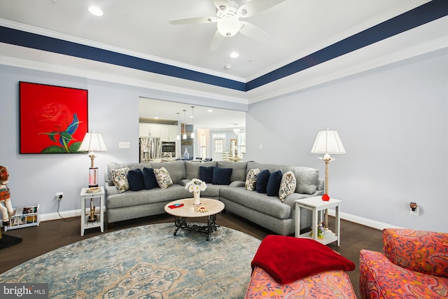 living room featuring ceiling fan, dark hardwood / wood-style floors, and ornamental molding