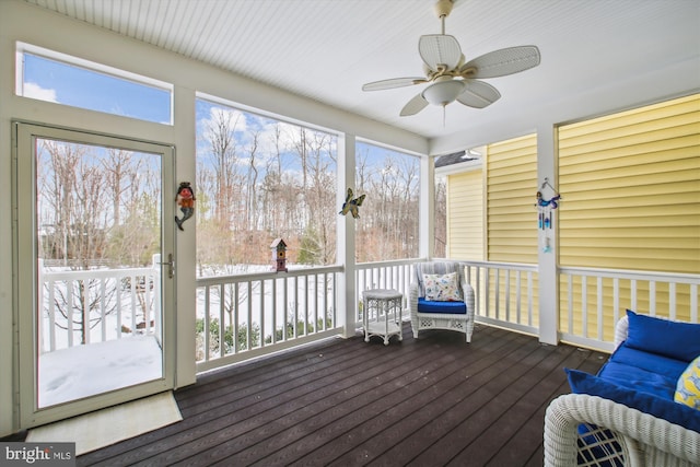 unfurnished sunroom featuring ceiling fan