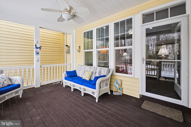 wooden deck featuring ceiling fan