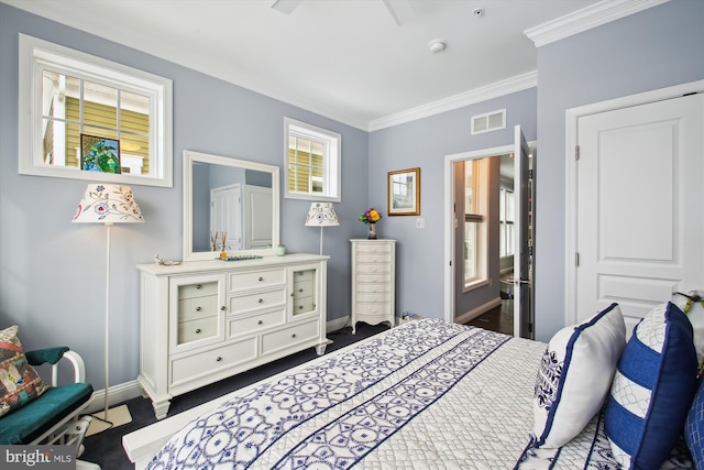 bedroom featuring crown molding, connected bathroom, and multiple windows