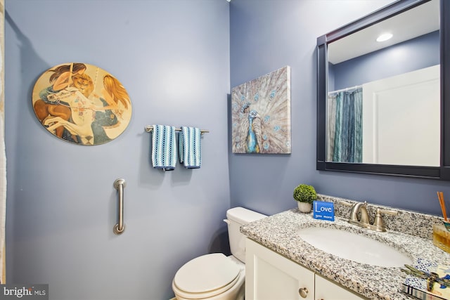 bathroom with toilet and vanity