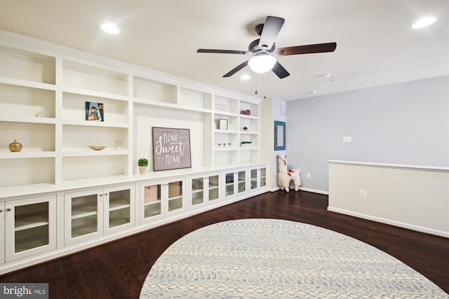 sitting room with ceiling fan and dark hardwood / wood-style floors