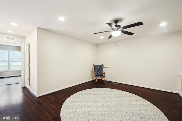 sitting room with ceiling fan and dark hardwood / wood-style flooring