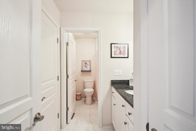 bathroom with toilet and vanity