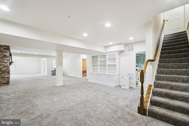 basement with carpet floors and built in shelves