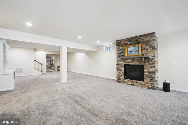 basement with carpet and a fireplace