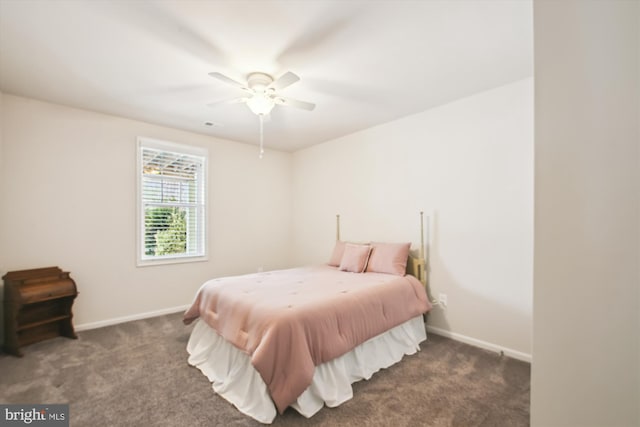 bedroom with ceiling fan and dark colored carpet