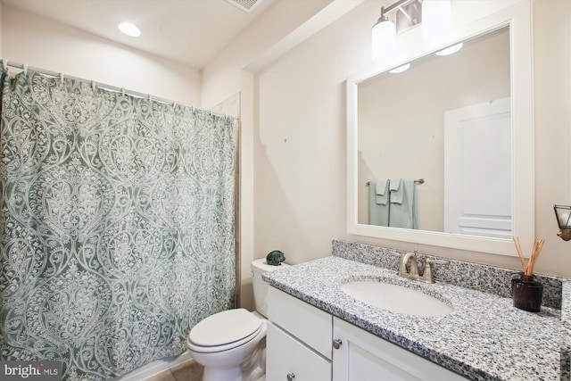 bathroom with toilet and vanity