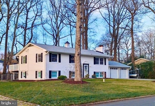 bi-level home with a garage and a front yard