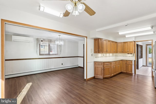 kitchen featuring a wall unit AC, pendant lighting, dark hardwood / wood-style floors, and baseboard heating