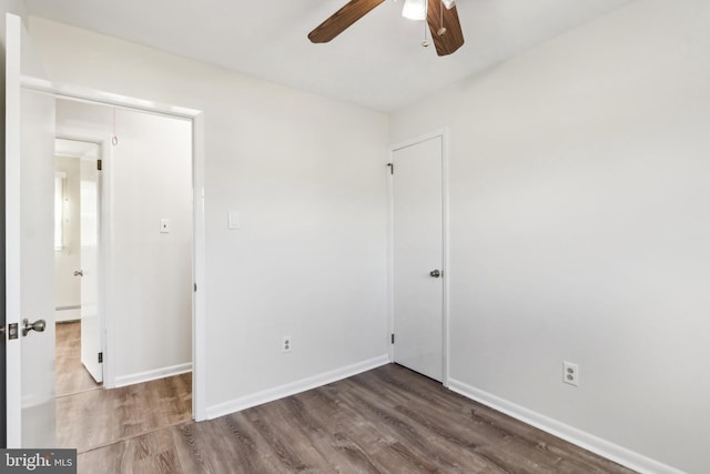 unfurnished room featuring hardwood / wood-style flooring, ceiling fan, and a baseboard heating unit