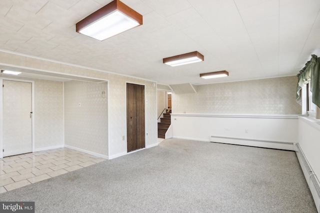 basement with carpet flooring and baseboard heating