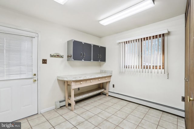 kitchen with light tile patterned flooring and a baseboard heating unit