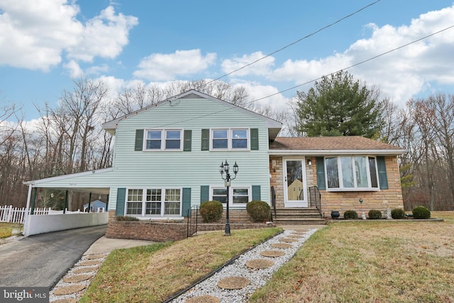 split level home with a front yard and a carport