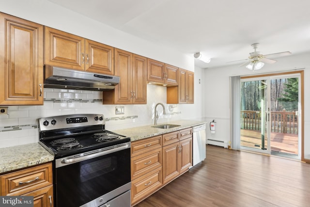 kitchen with stainless steel range with electric stovetop, dishwasher, sink, a baseboard radiator, and light stone counters