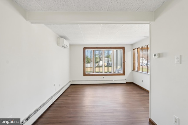 unfurnished room with a wall mounted air conditioner, dark hardwood / wood-style flooring, and a baseboard radiator