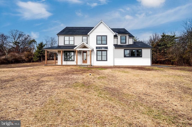 view of front of property featuring covered porch and a front yard