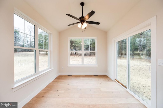 unfurnished sunroom with ceiling fan and vaulted ceiling