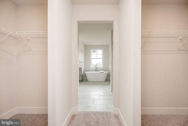 walk in closet featuring tile patterned flooring