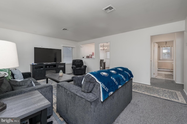 living room featuring carpet floors, a baseboard radiator, and a chandelier