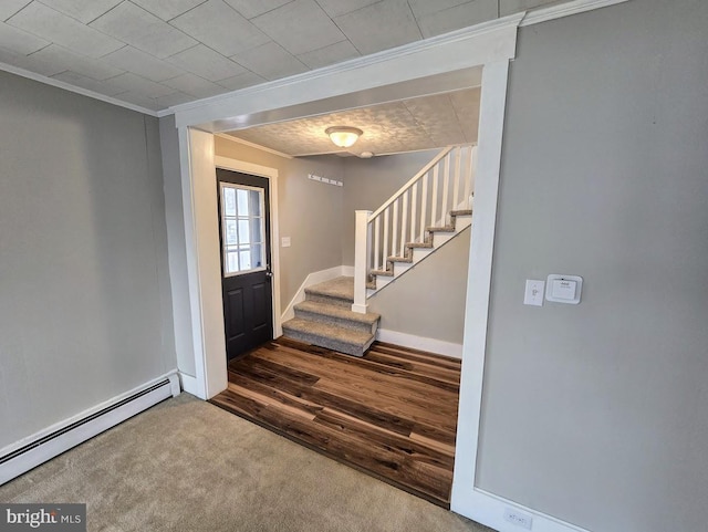 carpeted foyer entrance with ornamental molding and a baseboard radiator